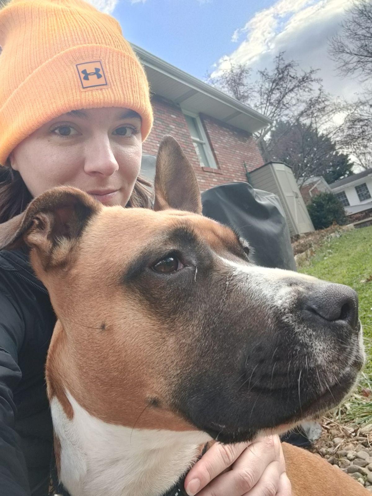 Smiling pet sitter with a dog